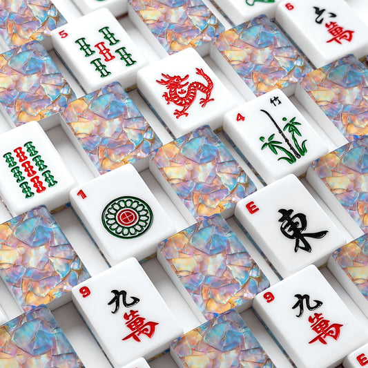 A close-up overhead view of Mahjong tiles arranged in a grid with mother of pearl design on the back
