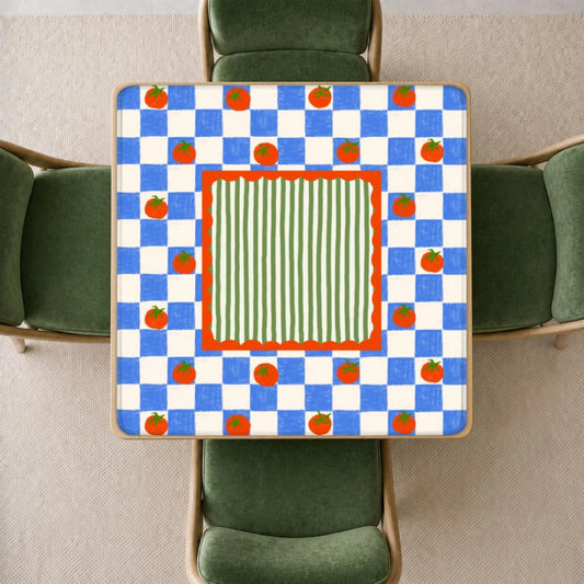 mahjong mat a colorful retro pattern featuring blue and white checkers, orange tomatoes, and a green striped center, surrounded by four green chairs.