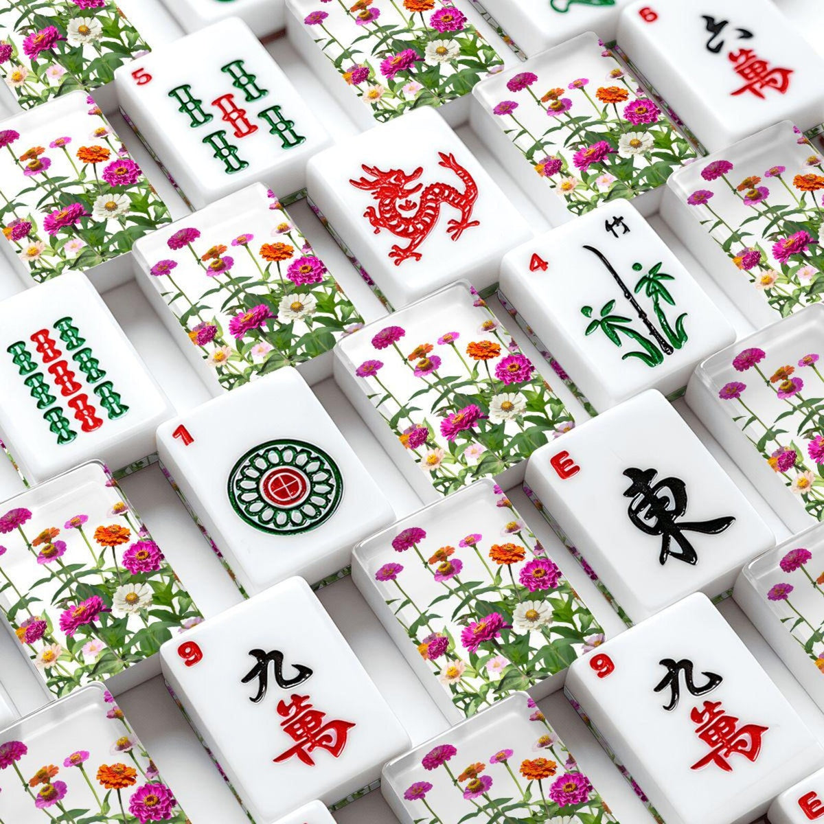 A close-up, top-down view of Mahjong tiles arranged in a grid. Tiles feature floral design with pink and orange lowers