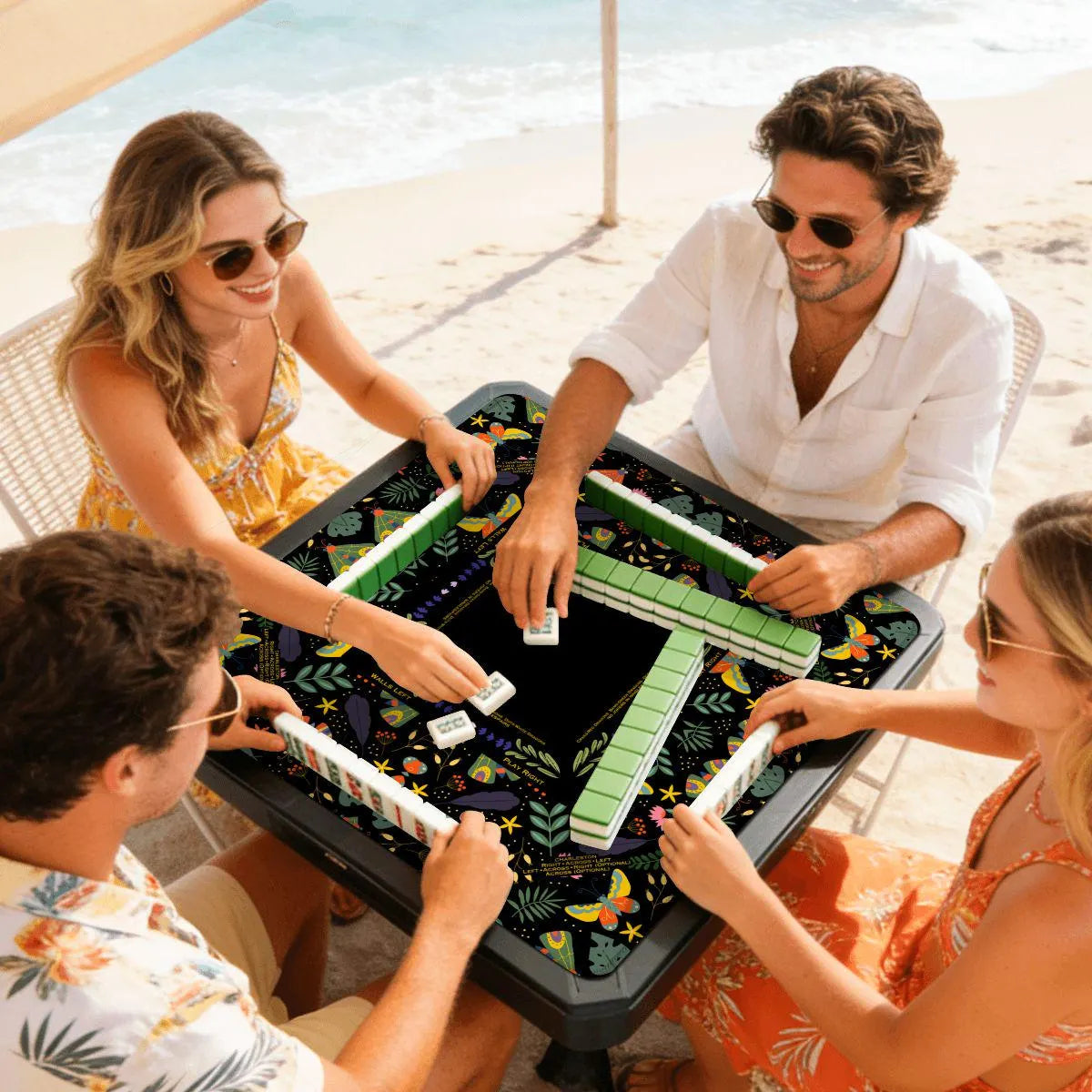 four people playing mahjong on a black mystic mahjong mat
