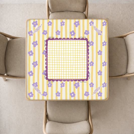 mahjong mat with a yellow and white striped pattern, purple floral accents, and a central purple frame, shown from above